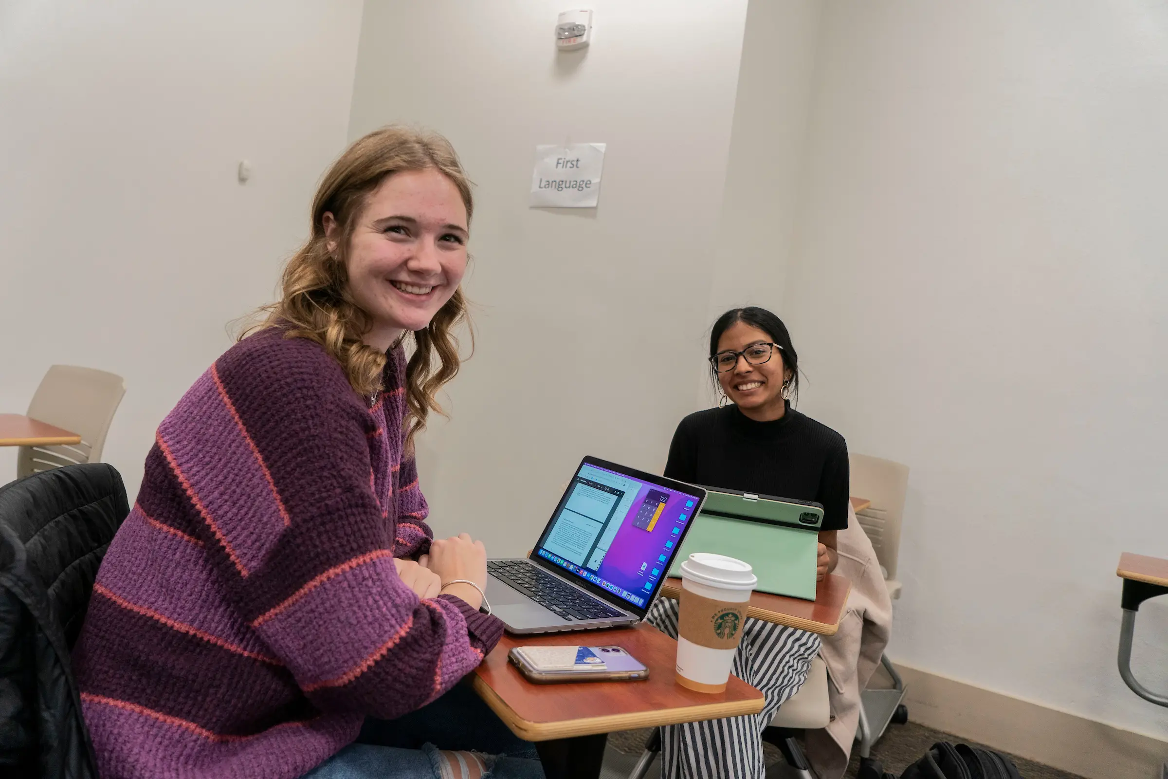 Students sit at desks in classroom